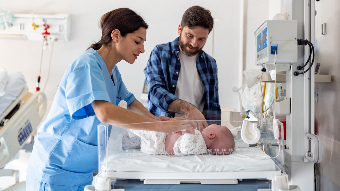 Nurse introducing father to newborn baby.jpg