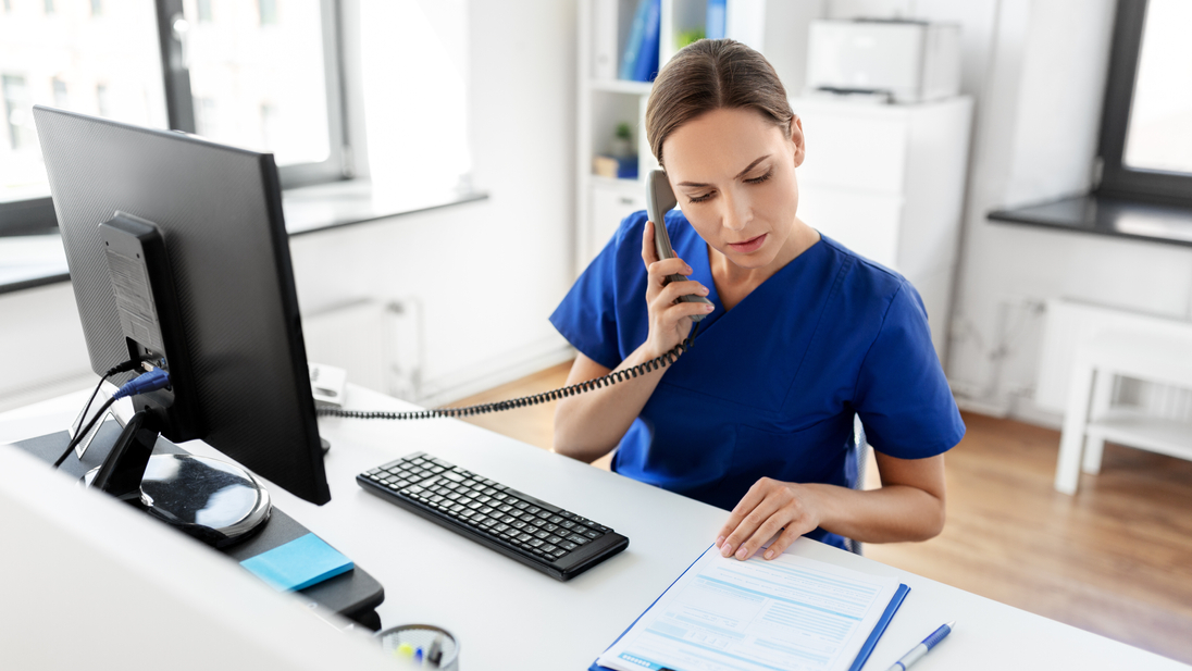 Nurse with computer making phonecall.jpg