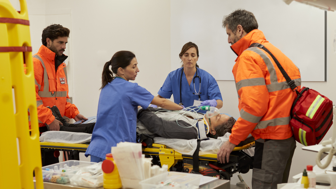 Nurses and emergency workers transferring a patient from the hospital gurney.jpg
