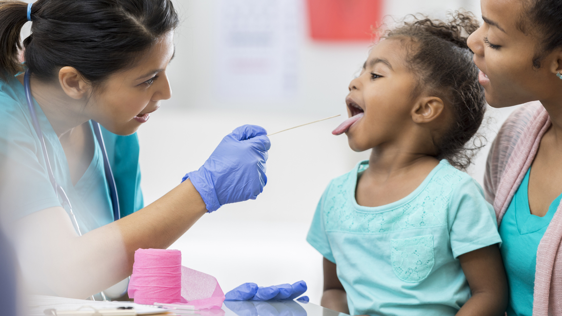 Pediatrician uses a tongue depressor.jpg