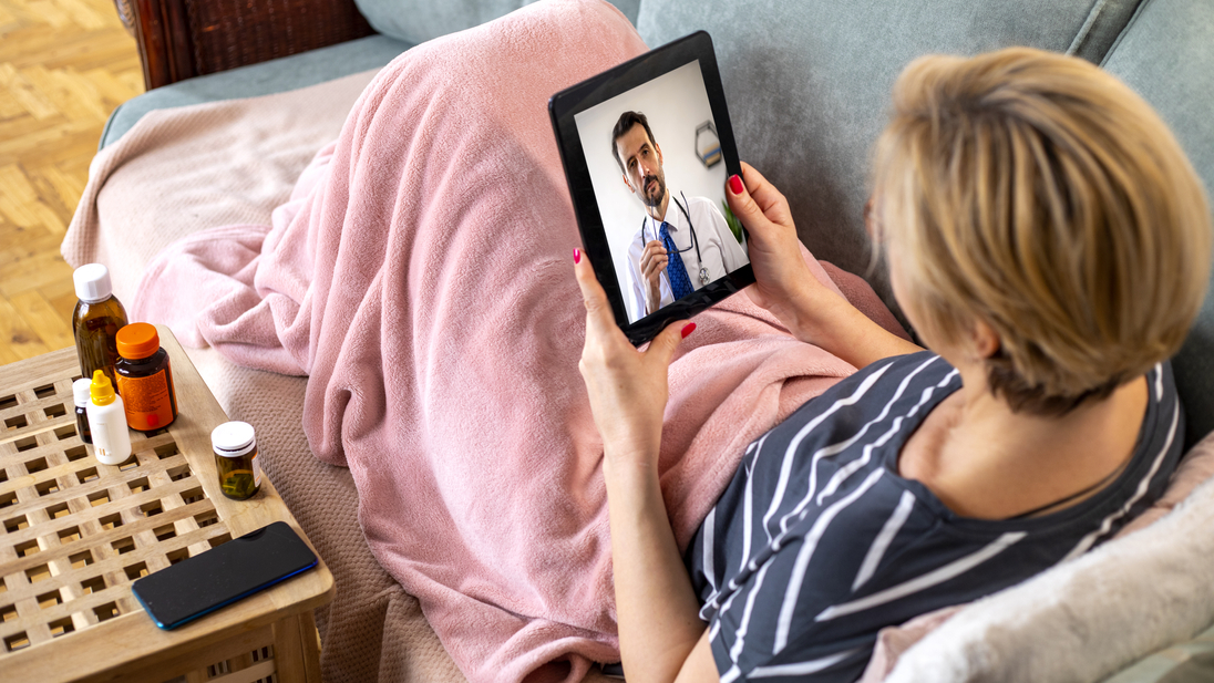 Woman using digital tablet for conversation with her doctor.jpg