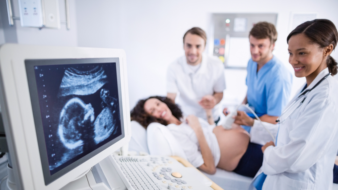 Doctor doing ultrasound scan for pregnant woman