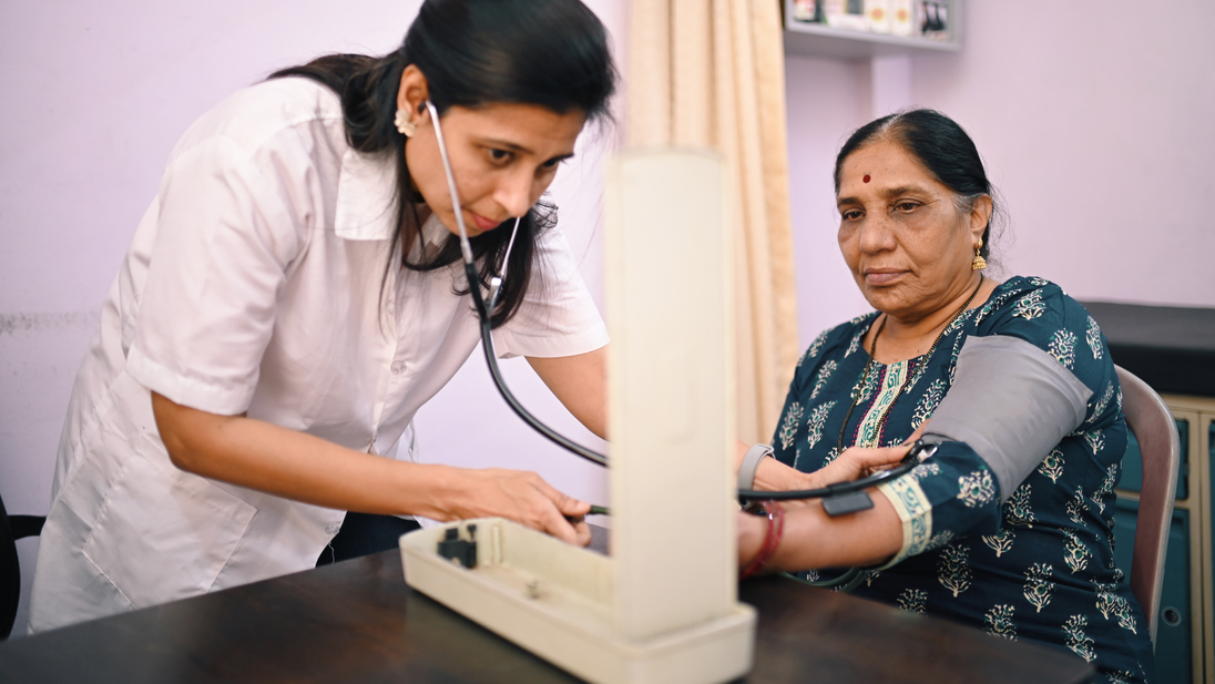 Female doctor examining blood pressure of a senior woman patient.jpg