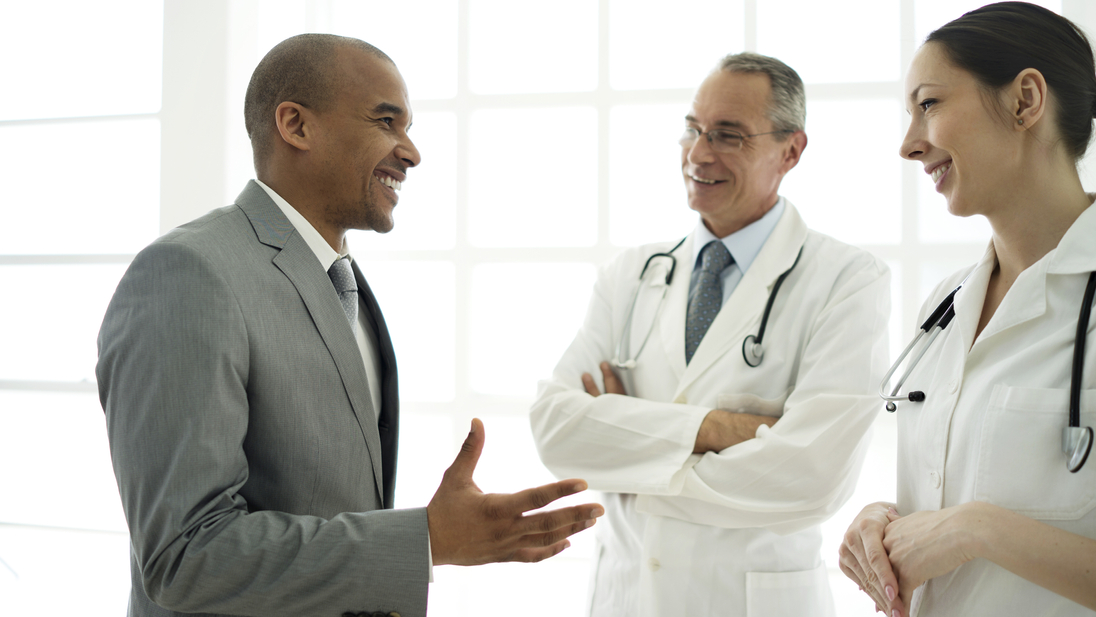 Businessman communicating with doctors.jpg
