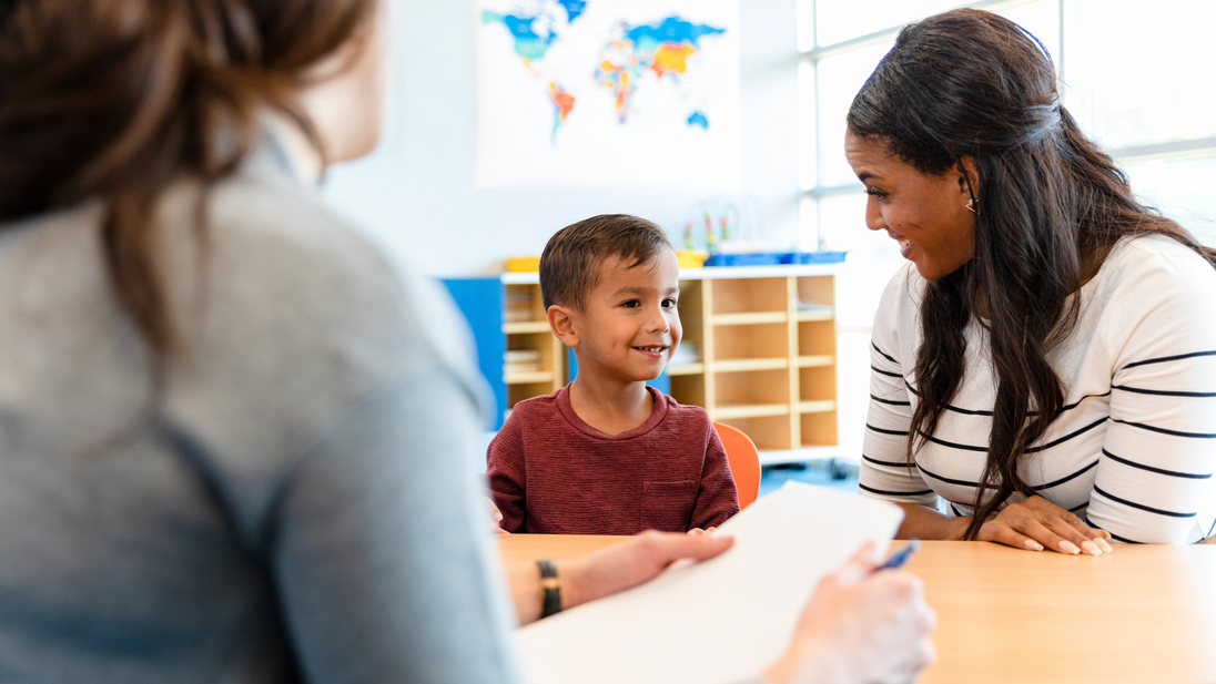 Child psychologist talks with young boy and his mom.jpg